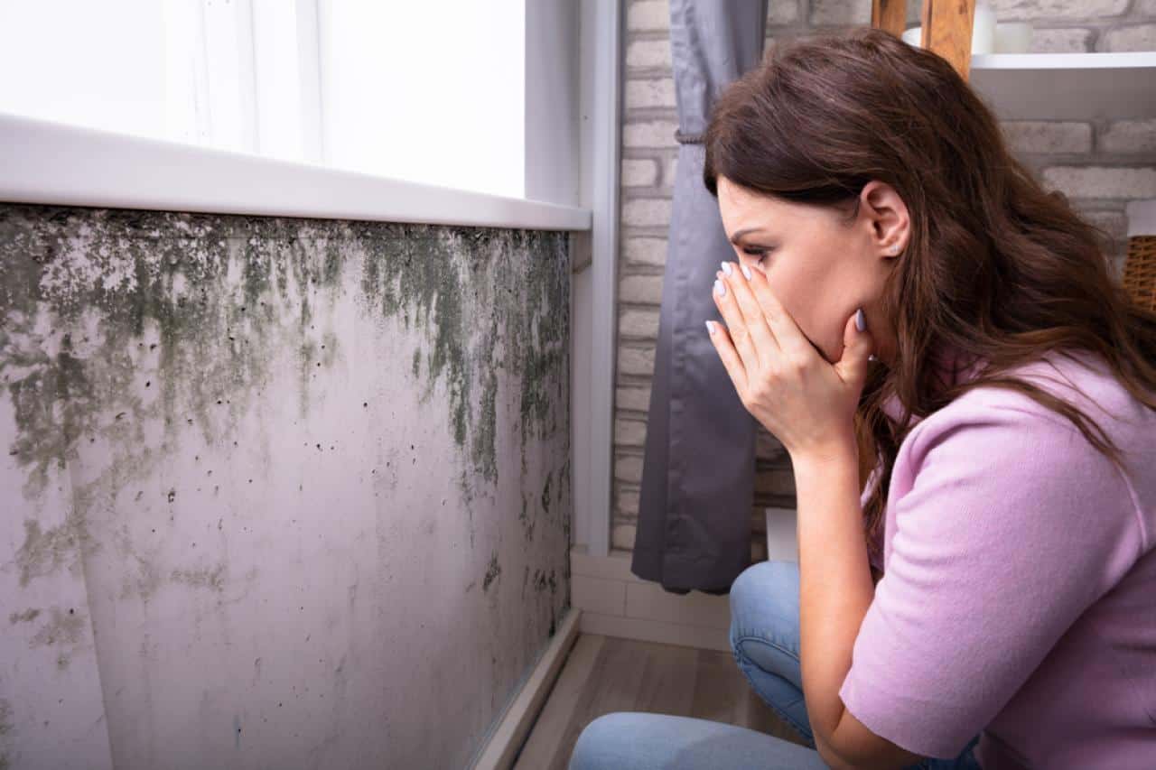 A woman upset with mold damage to her homes walls