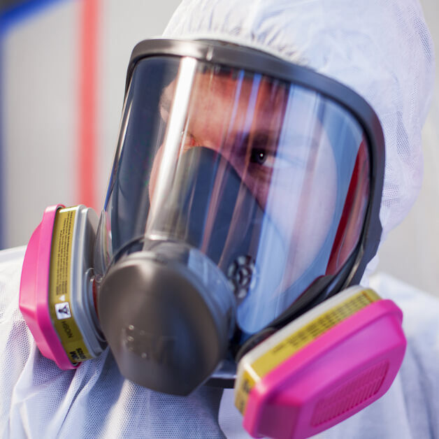 tech in full cover suit for property damage restoration
