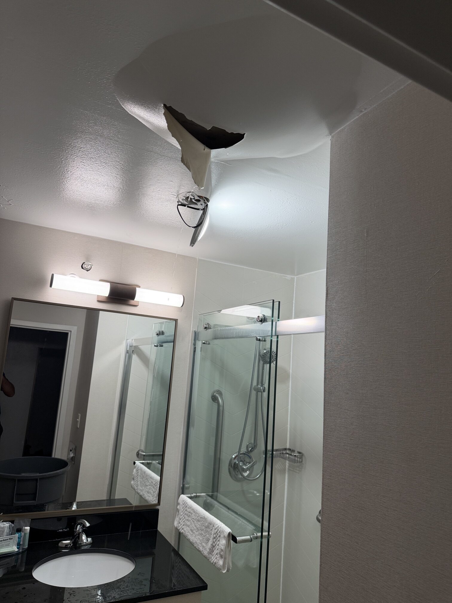 Water-damaged ceiling opened for access in a Northeast Ohio hotel bathroom