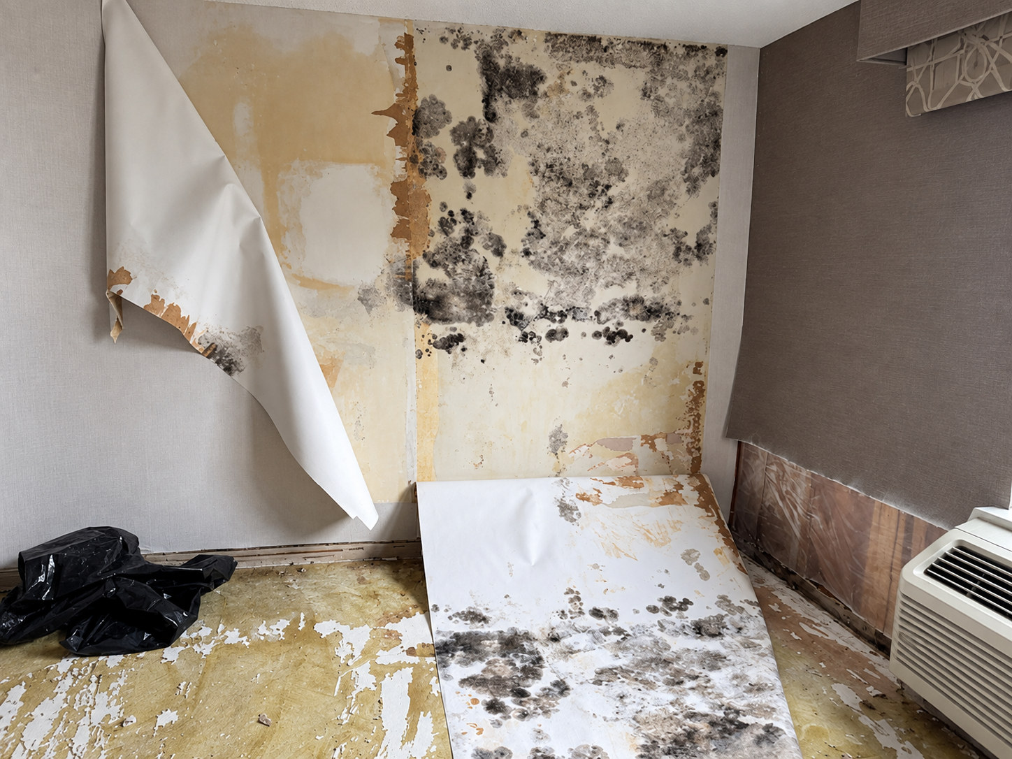 Hotel room with extensive visible wall and material damage