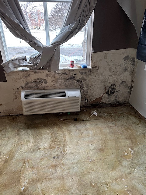 Commercial room with visible moisture-related wall and material damage