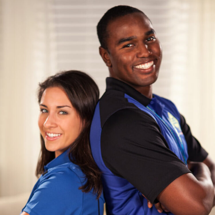 Two 1-800 Water Damage technicians standing back to back