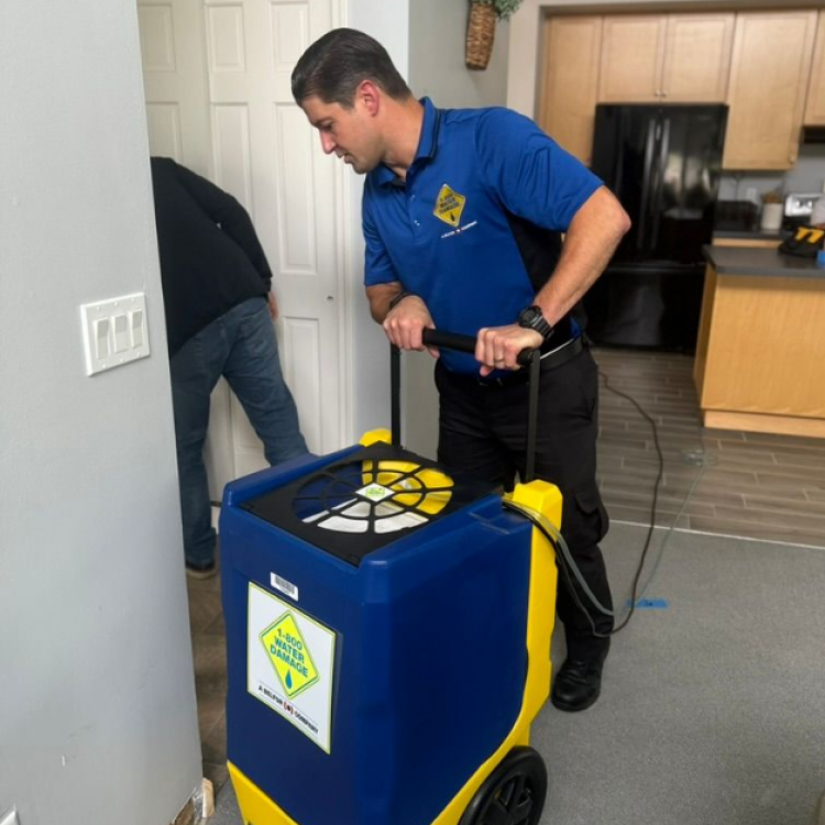 A Member of the 1800 Water Damage Western CO team using specalized equipment