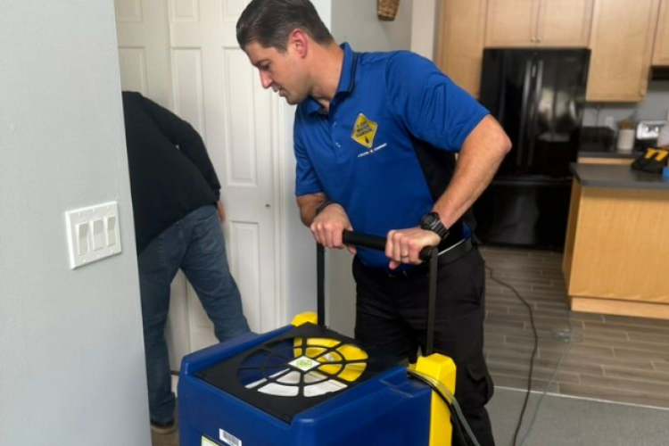 A Member of the 1800 Water Damage Western CO team using specalized equipment