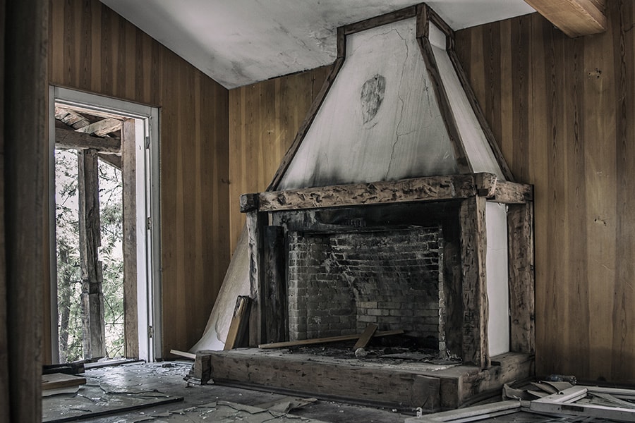 A fireplace in a home with fire and smoke damage