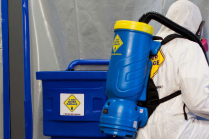 Two biohazard technicians performing cleanup services