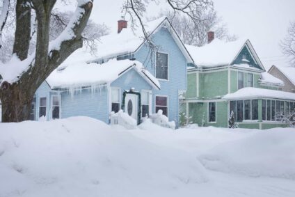Large homes and yards covered in snow