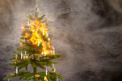 a concept image of a burning christmas tree because of the candles