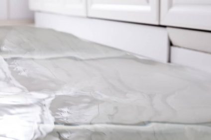 Flooding inside home on white tile floor