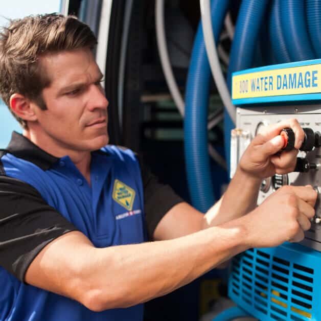 Service technician from 1-800 Water Damage in a van, equipped for efficient and reliable water damage restoration services on the go
